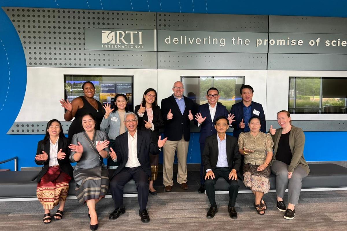 Group of people in front of a sign with the RTI International logo